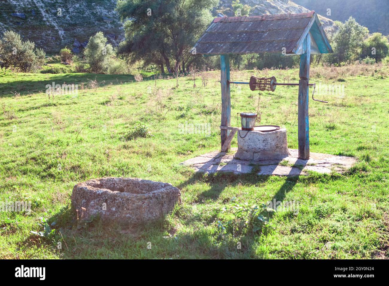 Rustic Source of drinking water . Well on the meadow in the village