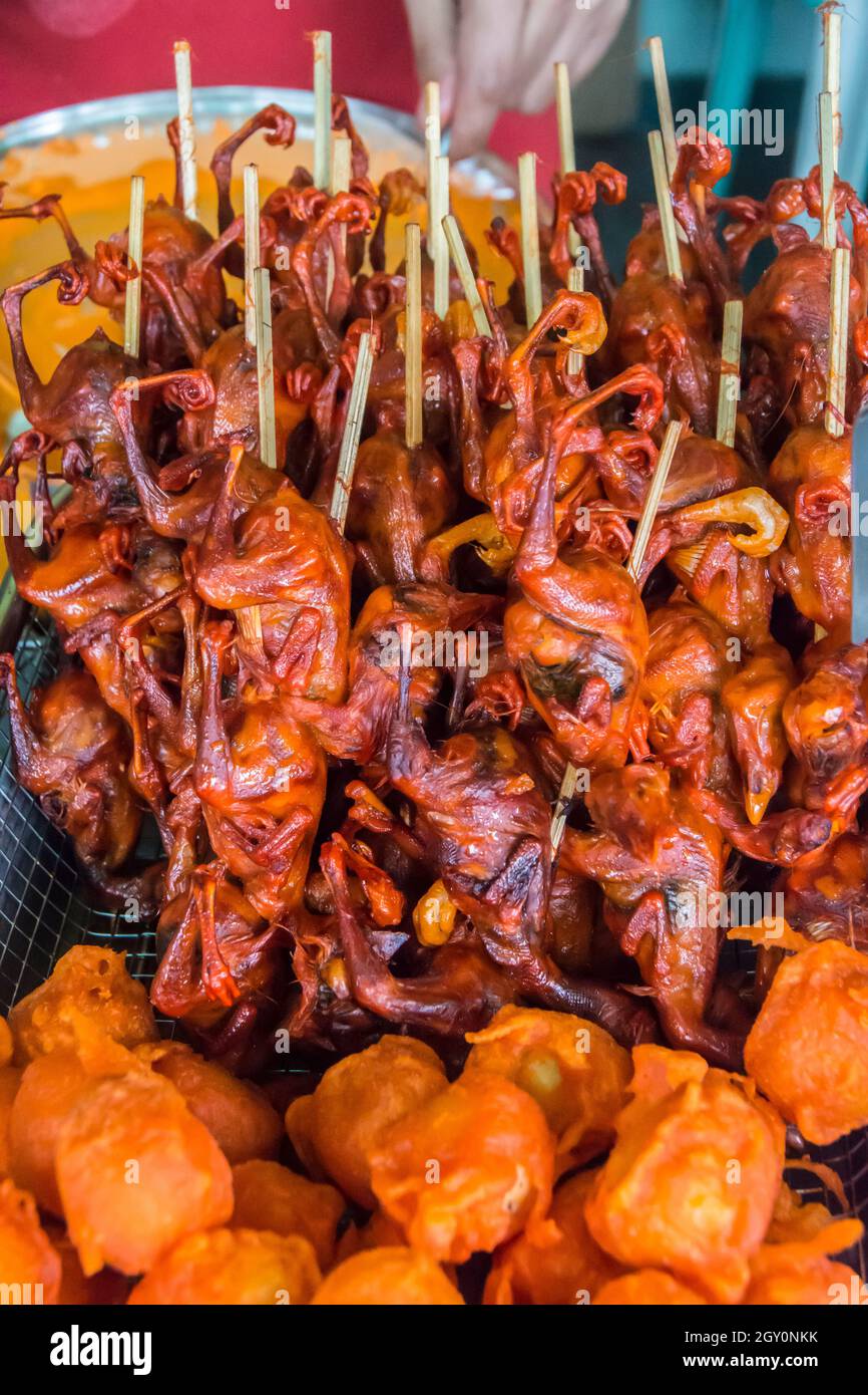 Filipino street food. Skewered deep fried one day old chicks. . Stock Photo