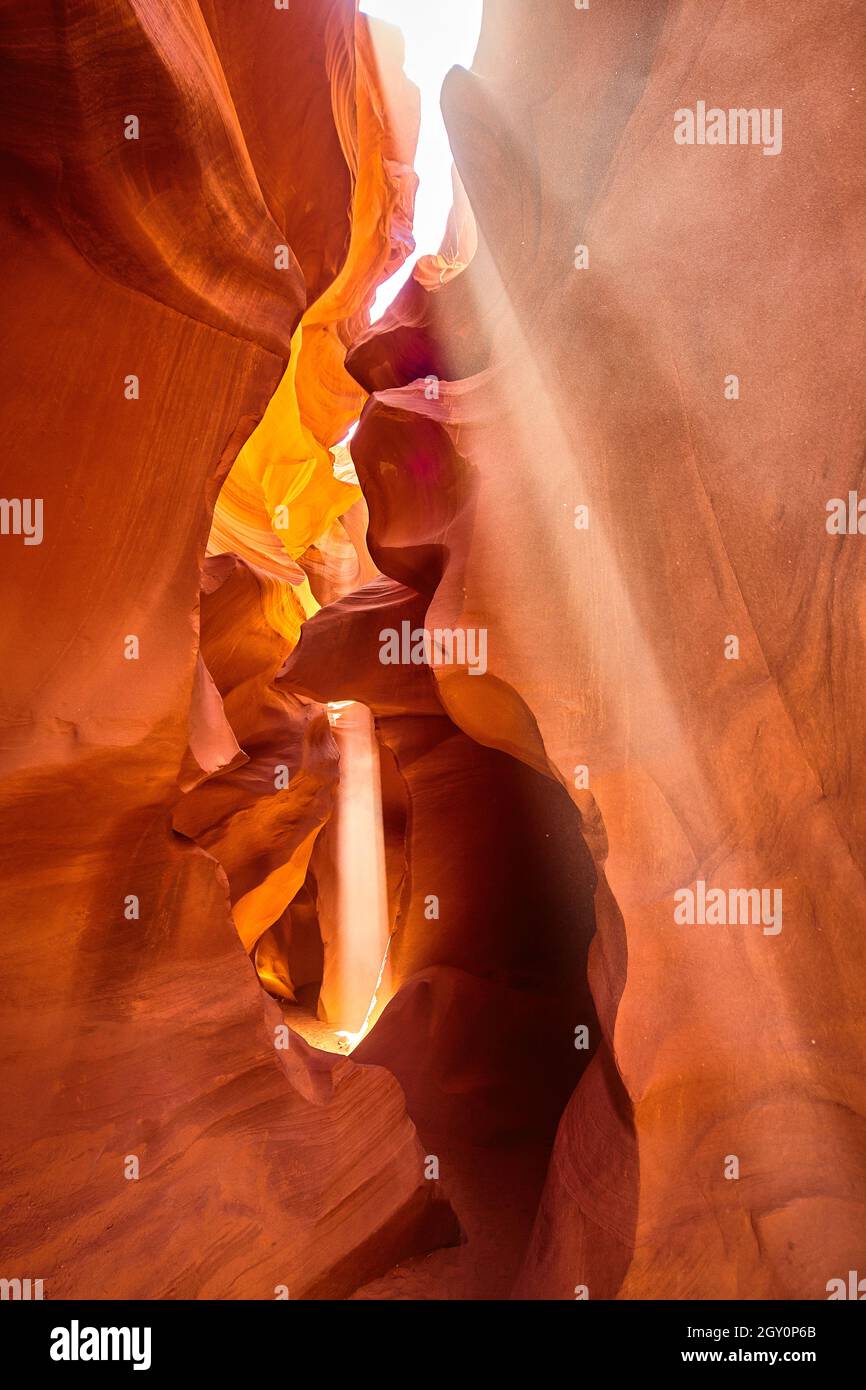 Light filters into an orange canyon portrait Stock Photo