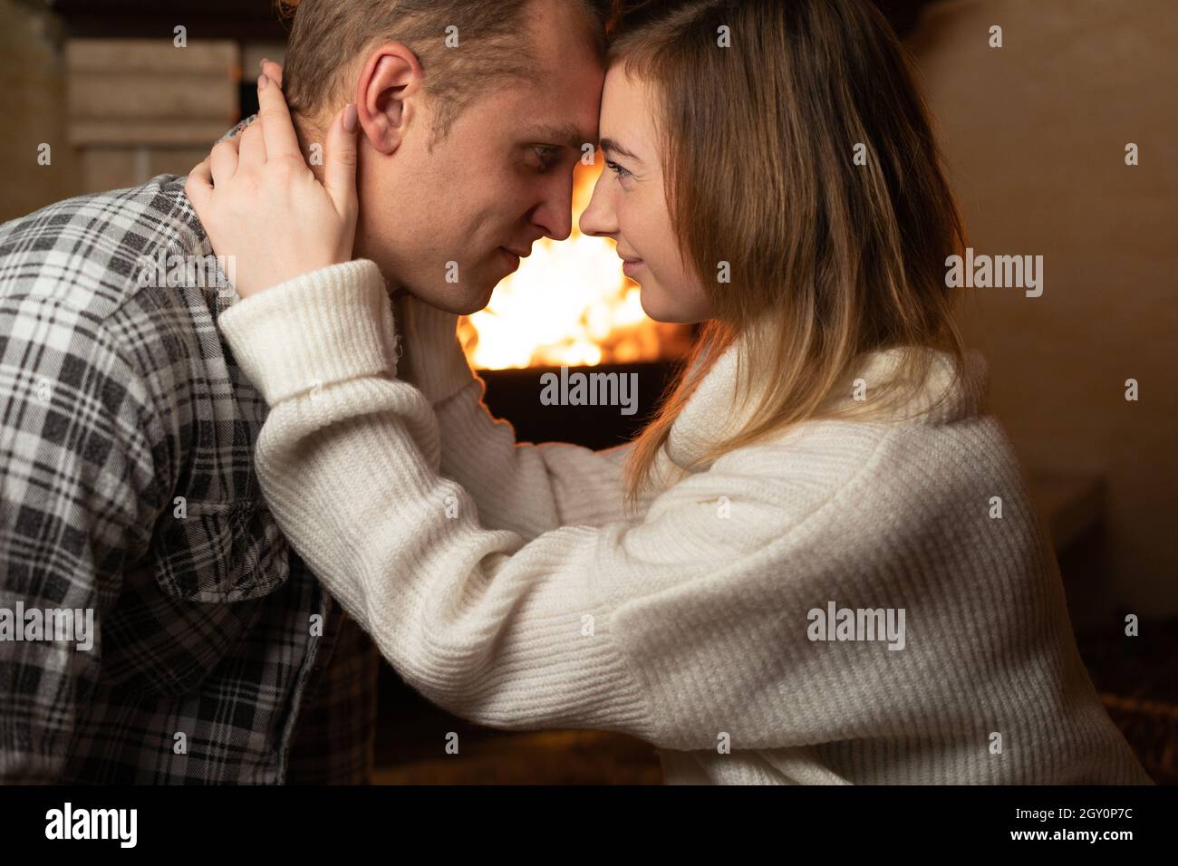 Portrait of a man and a woman embracing his neck. Love and romance. Young family and holidays concept. Stock Photo