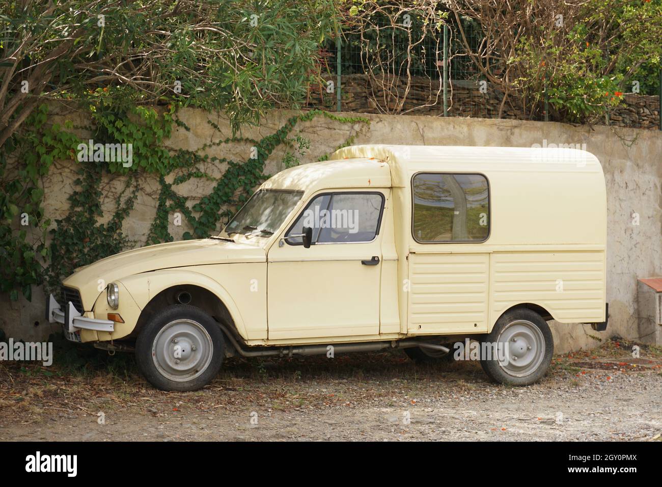 Vintage Citroen van, yellow in colour, parked on street outside house in village in France Stock Photo