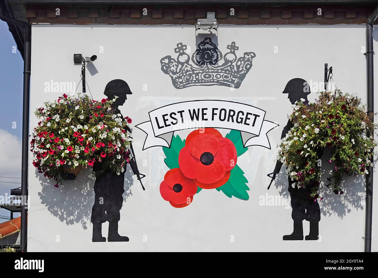 Artist creation of poppies in a Lest We wall mural at The Crown