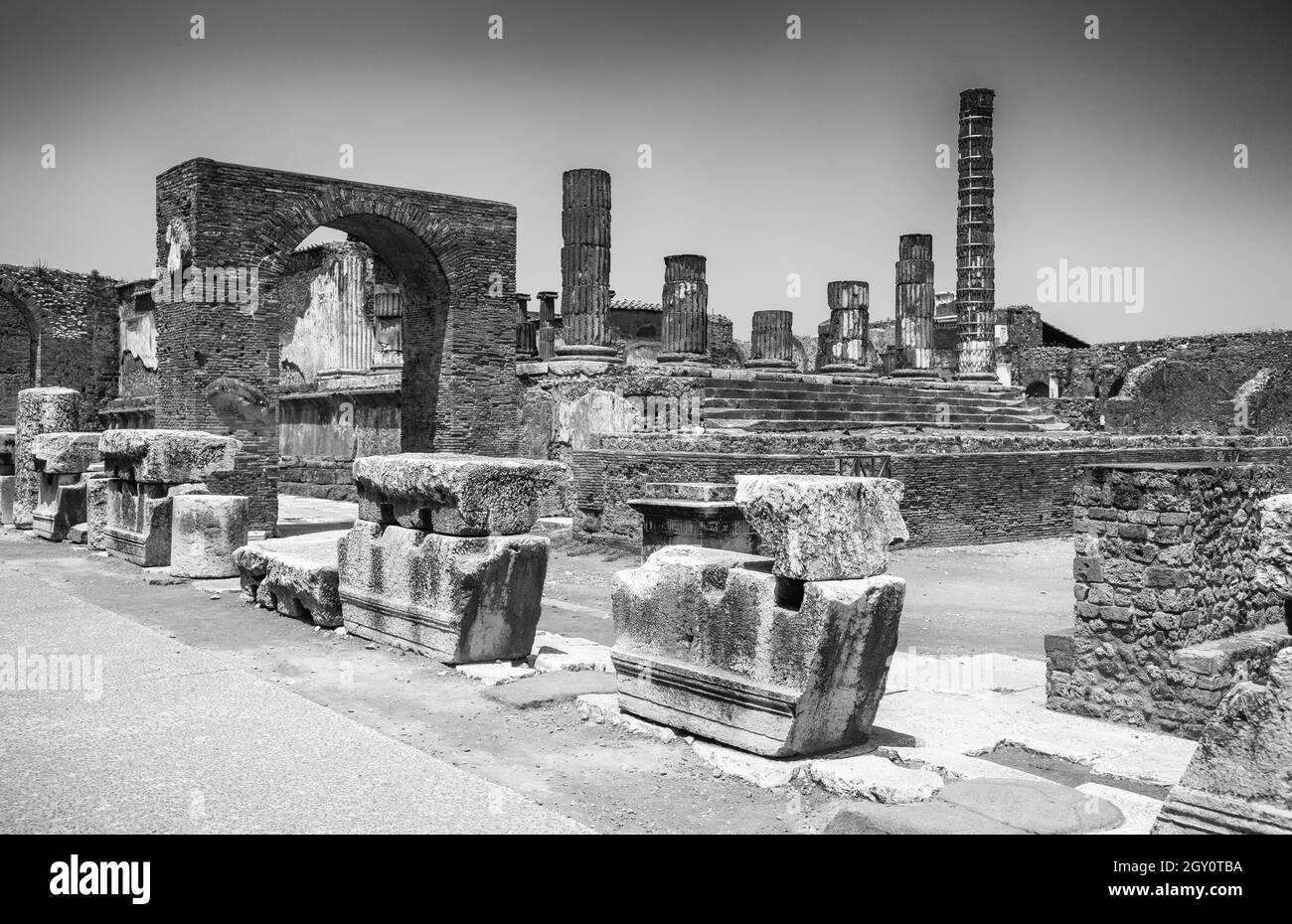 Grayscale shot of ancient Pompeii city ruins in Italy destroyed by the eruption of Mount Vesuvius Stock Photo