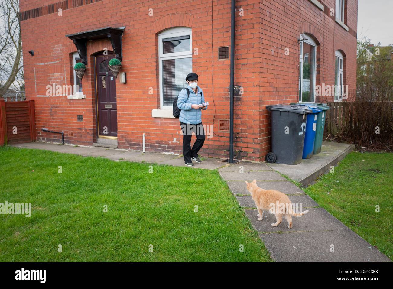 Jihyun Park, a North Korean defector who is standing as a Conservative Party MP for Bury, delivers campaign literature to local residents in Bury, Lancashire, UK Stock Photo