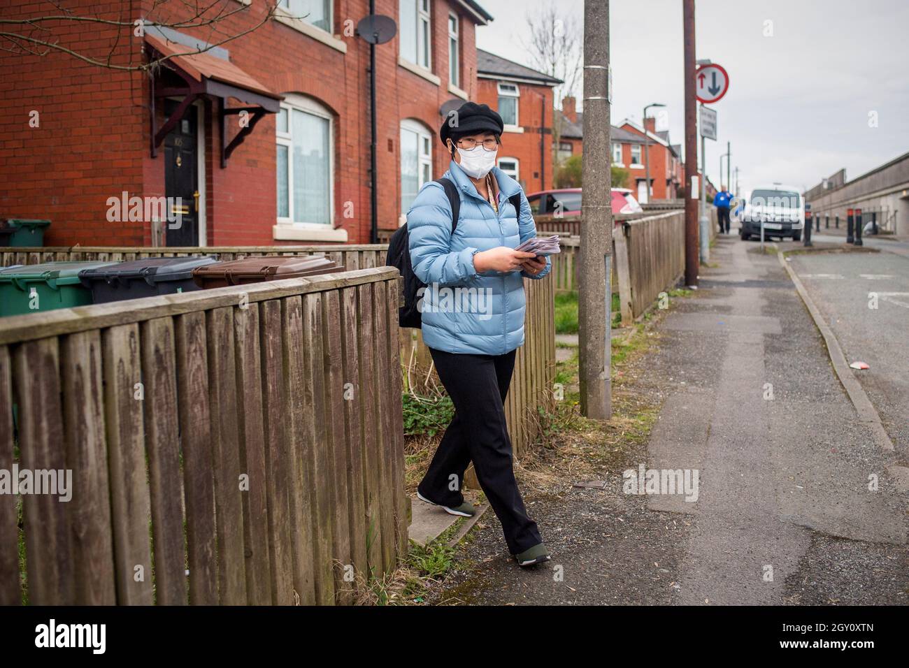 Jihyun Park, a North Korean defector who is standing as a Conservative Party MP for Bury, delivers campaign literature to local residents in Bury, Lancashire, UK Stock Photo
