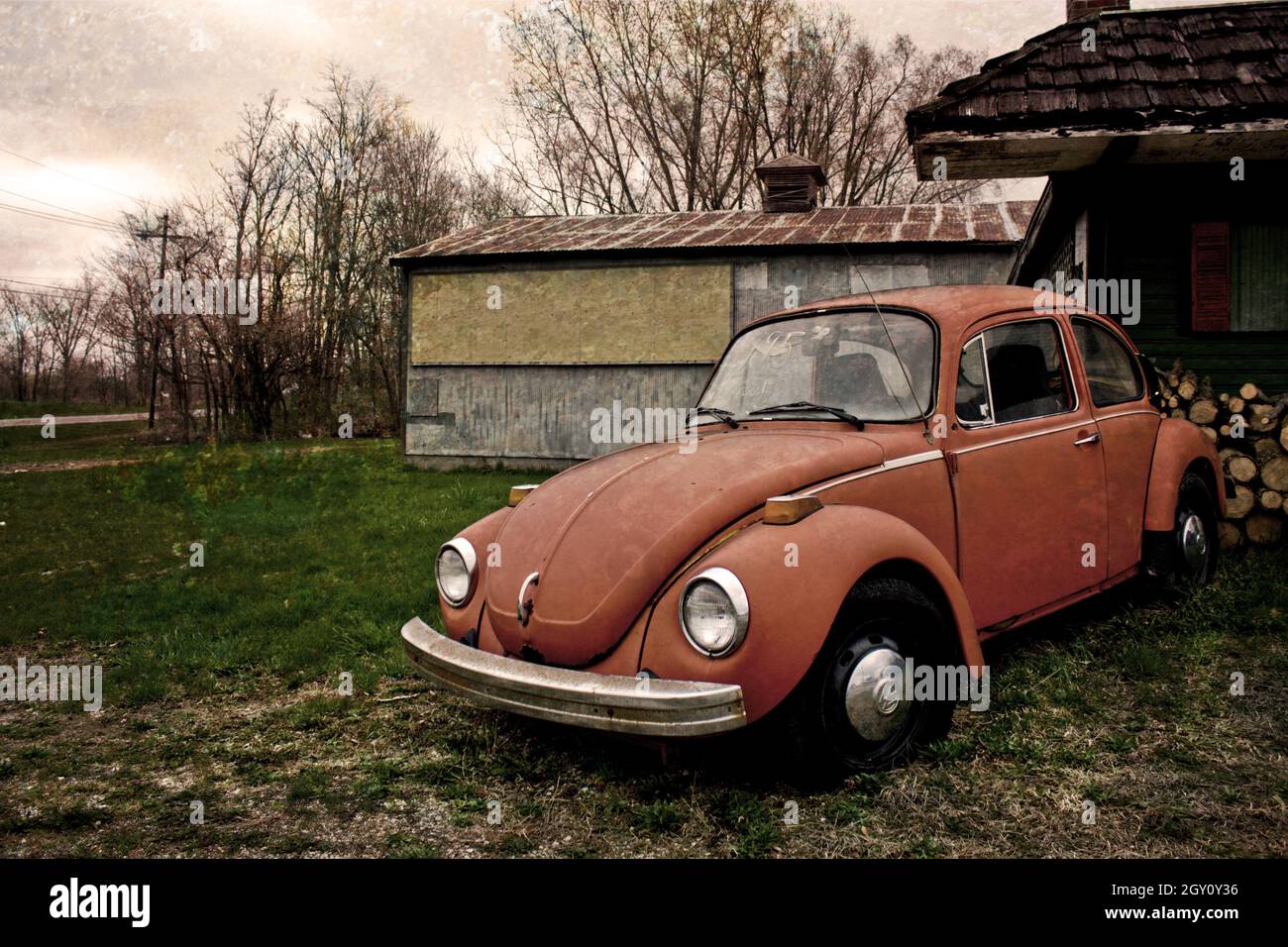 Vintage photo with muted colors of an old VW Beetle with a home and ...