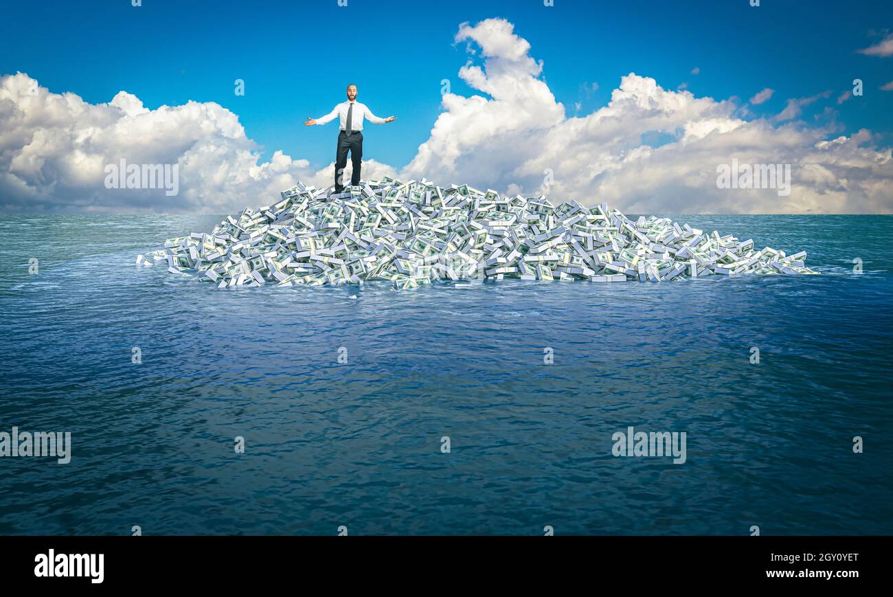 man with displeased expression on an island made of dollar money in the middle of the sea. Stock Photo