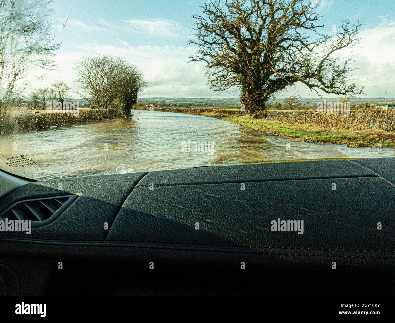 Driving through water on flooded road Stock Photo