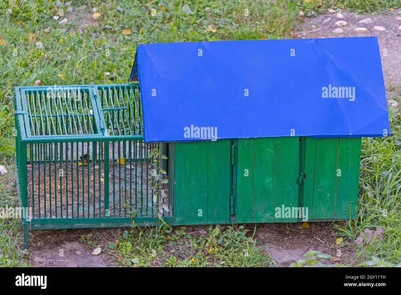 Green Chicken Coop With Blue Roof in Garden Stock Photo