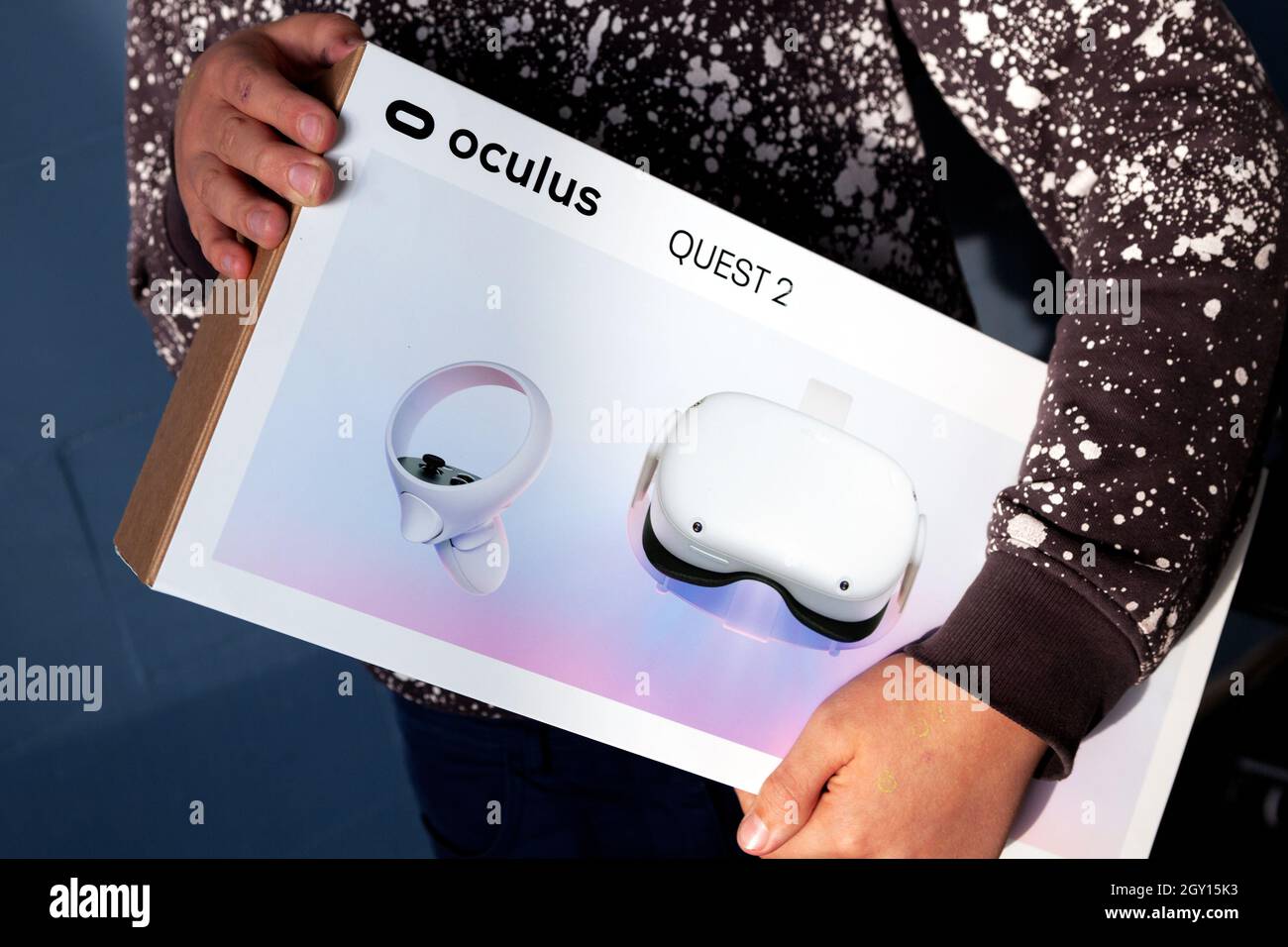 Child holds new VR head set box. A new generation gaming device for entertainment and sport. Oculus Quest 2. Stock Photo