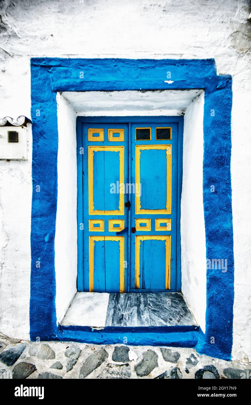 Blue-painted doo of a building in Macharaviaya, Malaga, Spain Stock Photo