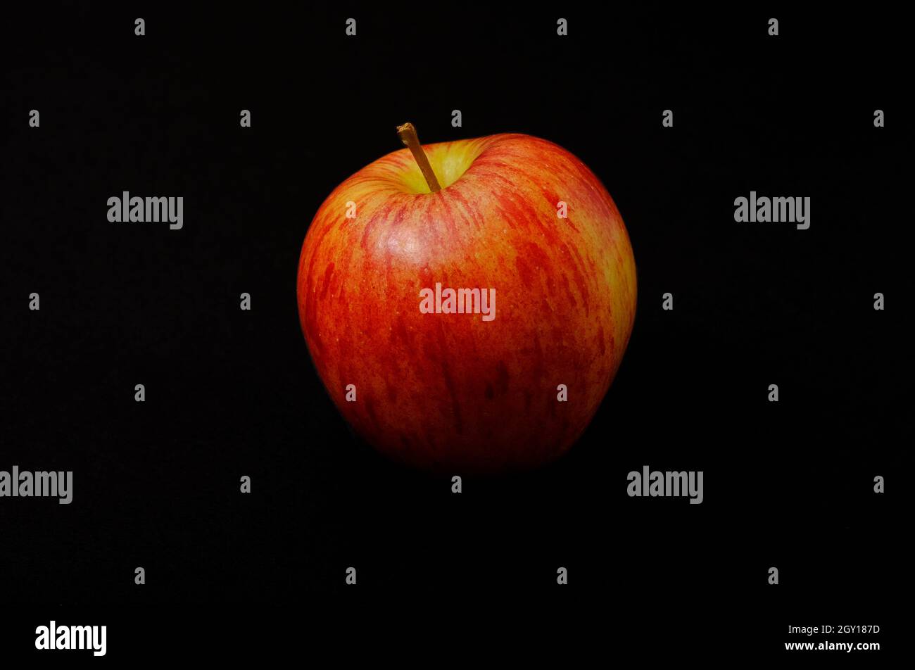 braeburn apple on dark black background Stock Photo