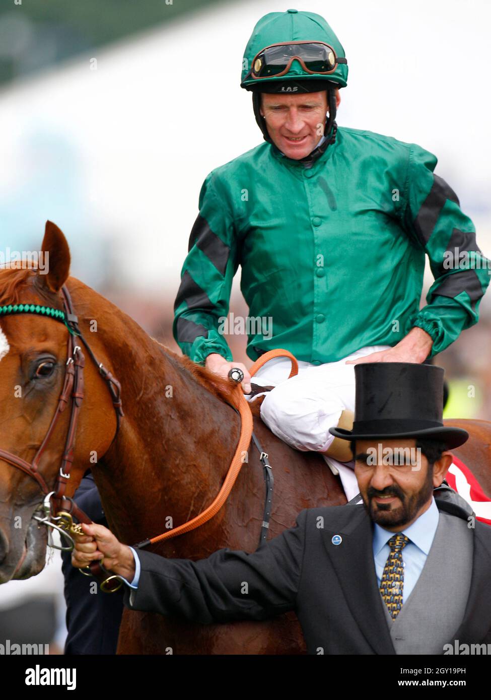 File photo dated 7/6/2008 of jockey Kevin Manning on New Approach beinglead into the winner's enclosure by Sheikh Mohammed bin Rashid Al Maktoum after winning The Vodafone Derby at Epsom Downs Racecourse, Surrey. The ruler of Dubai authorised the hacking of his former wife and her lawyers' phones with multi-million-pound spyware during a legal battle over their two children, the High Court has found. Sheikh Mohammed bin Rashid Al Maktoum, 72, gave his 'express or implied authority' for the phone of his sixth wife Princess Haya Bint Al Hussein, 47, to be infiltrated with Pegasus spyware during  Stock Photo