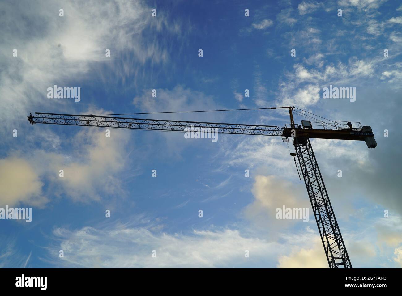 Low angle shot of a working crane under the cloudy skies Stock Photo ...