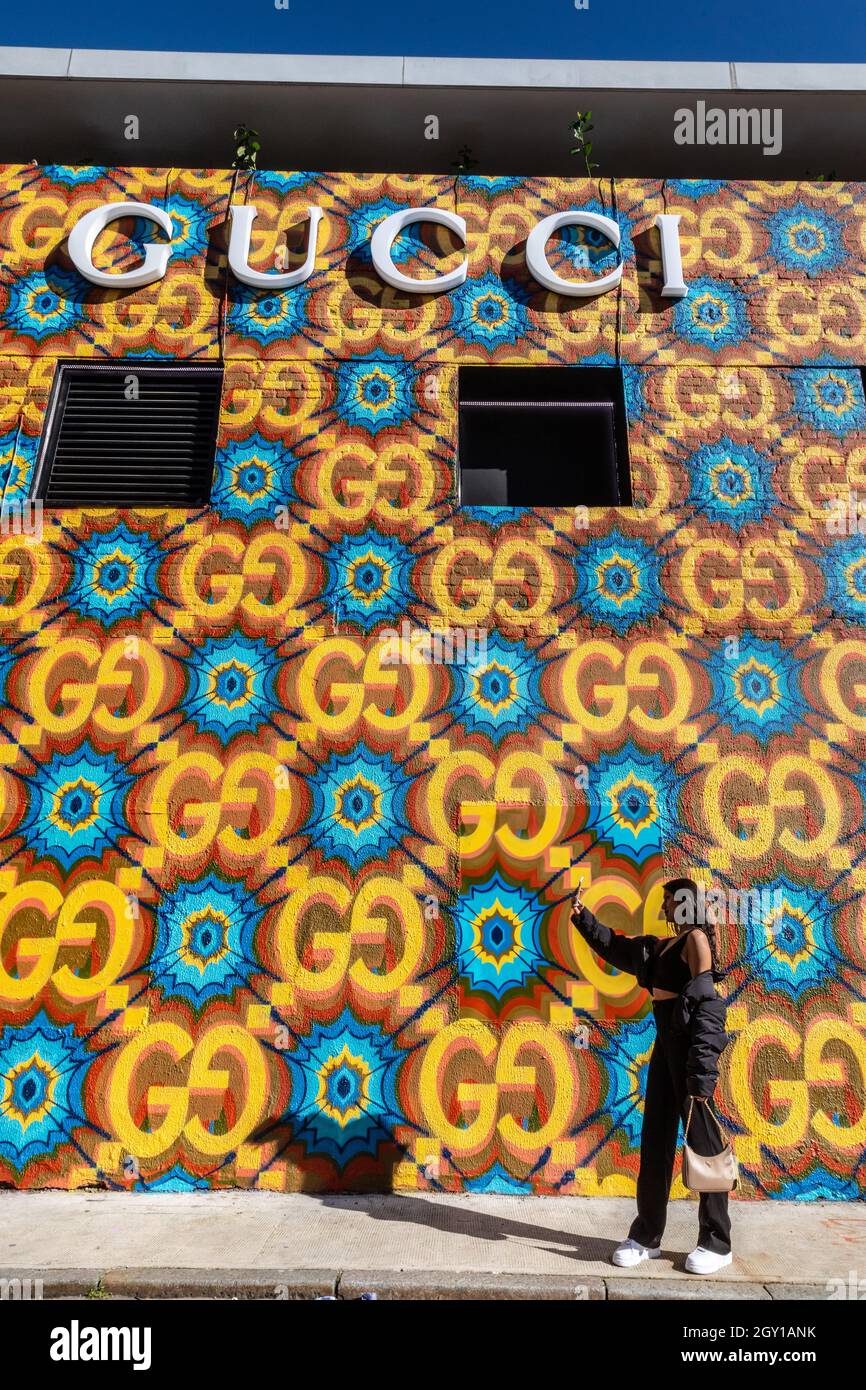London, UK. 06th Oct, 2021. A young woman takes photos of the colourful  store exterior. A new Gucci 'Circolo' pop up store opens in London's trendy  Shoreditch neighbourhood. The store features a