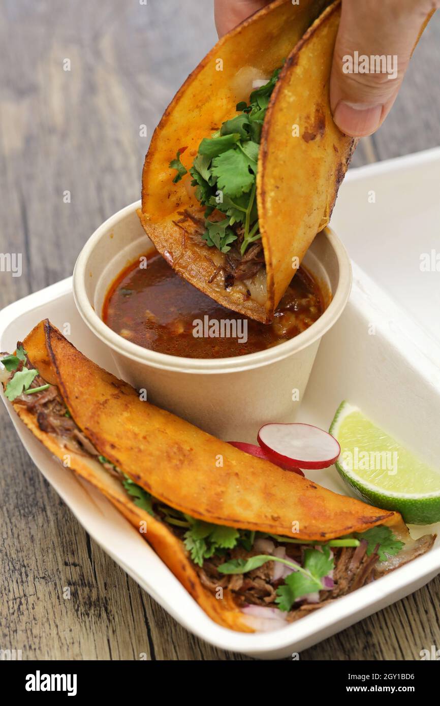 birria tacos with broth for dipping, mexican food Stock Photo