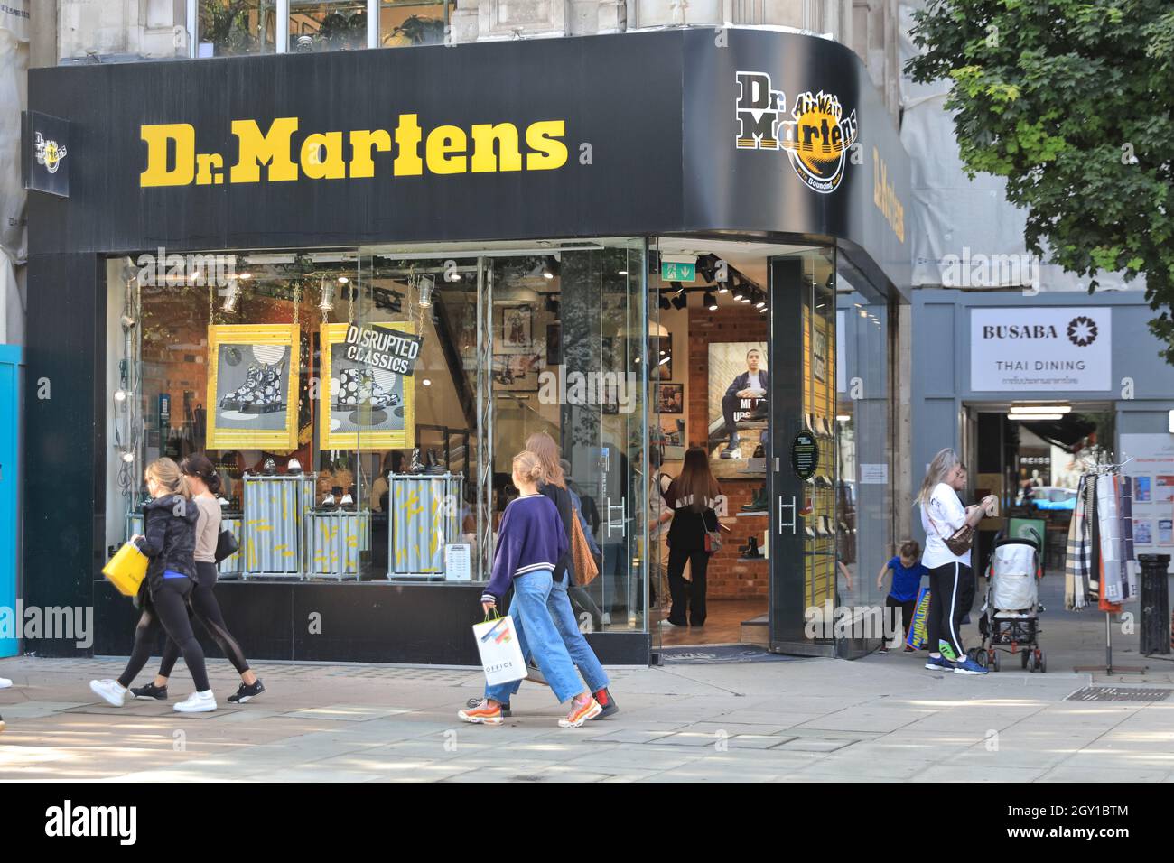 Dr. Martens British shoe shop exterior, people walking past footwear retailer on Oxford Street, London, England Stock Photo