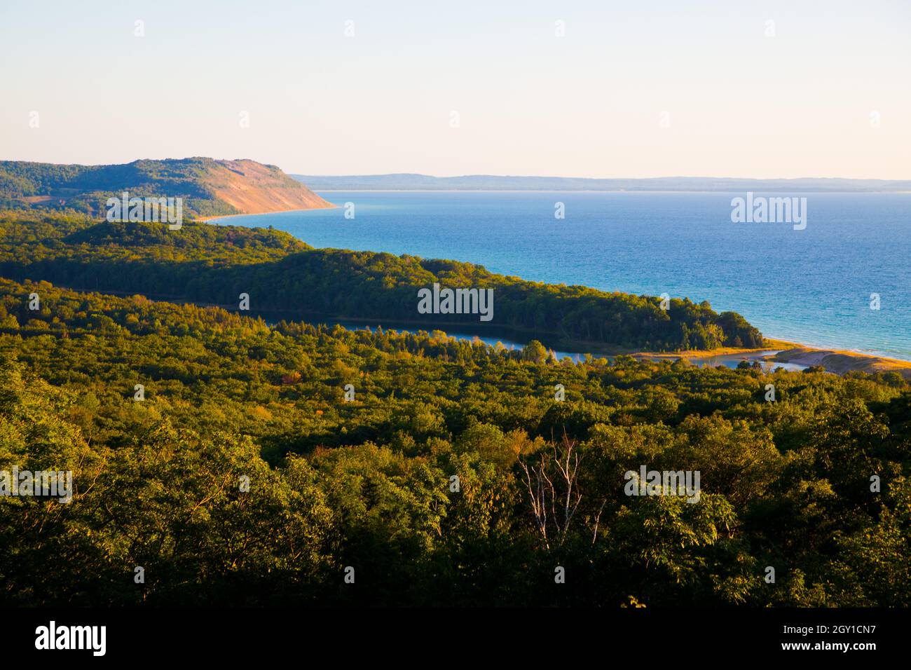 Landscape of trees and a large body of blue water on a clear day Stock Photo