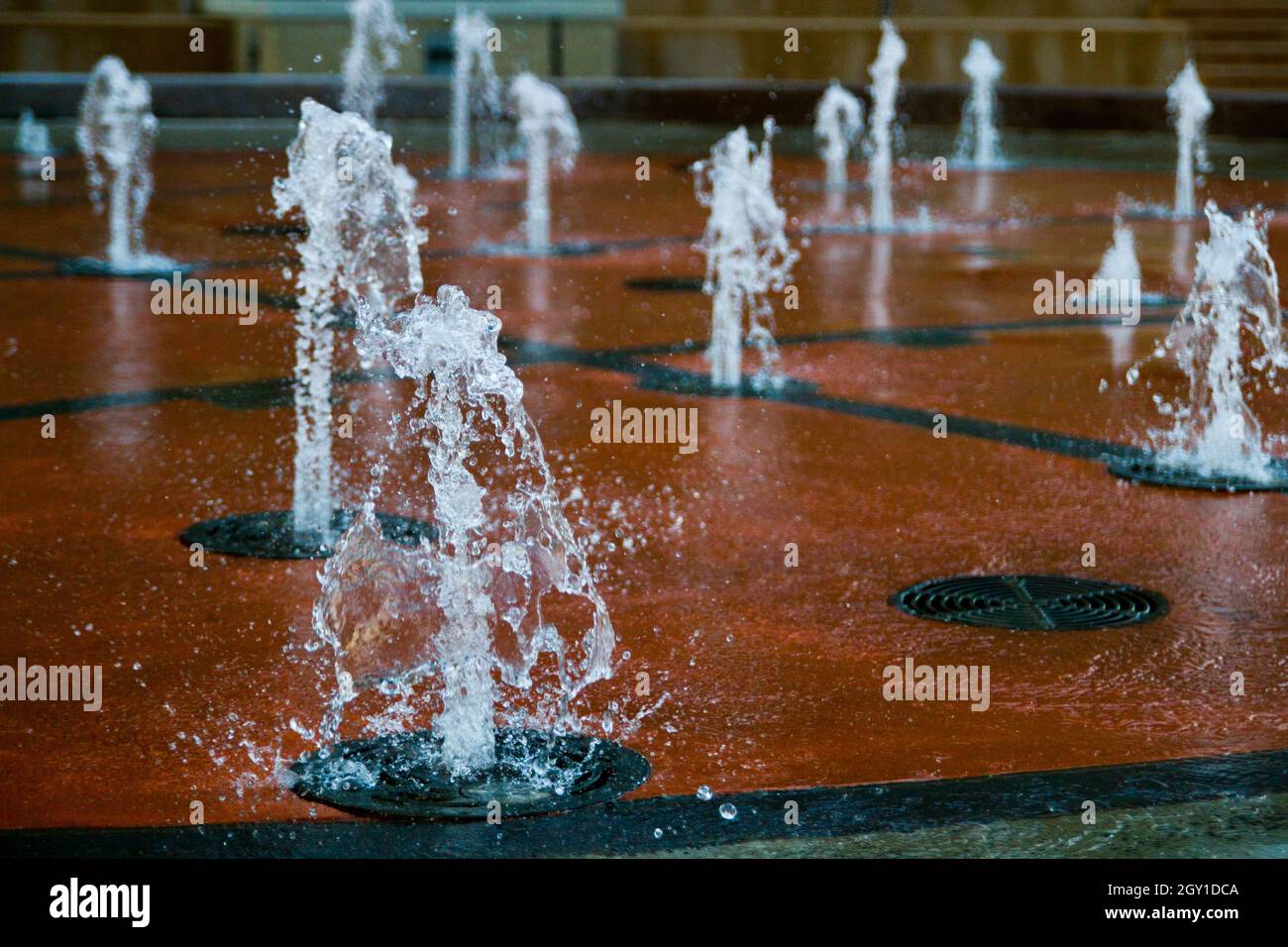 Water shooting up from the ground in a park in Louisville Stock Photo