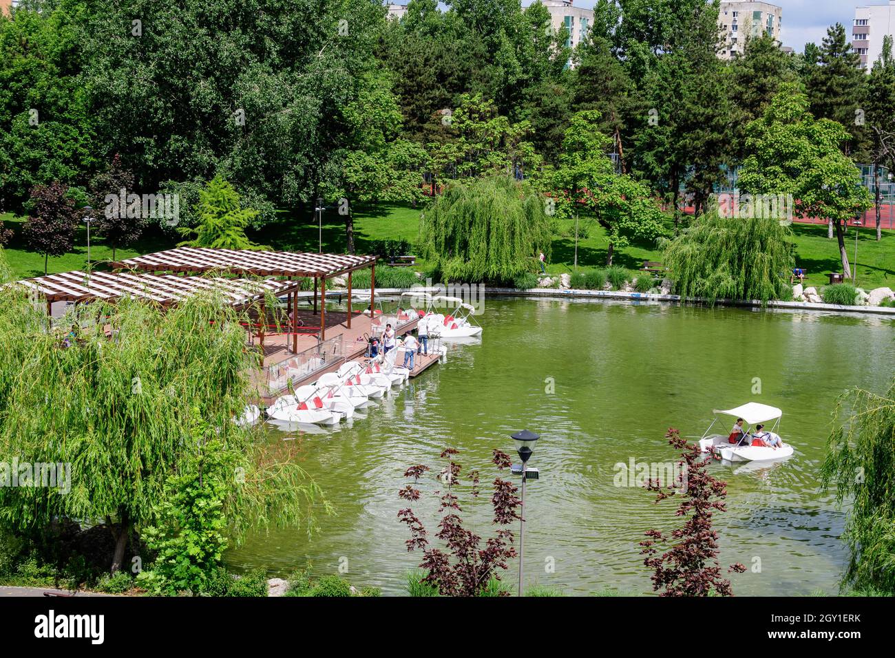 Bucharest, Romania - 29 May 2021: Landscape with lake and vivid green trees in Drumul Taberei Park (Parcul Drumul Taberei) also known as Moghioros Par Stock Photo