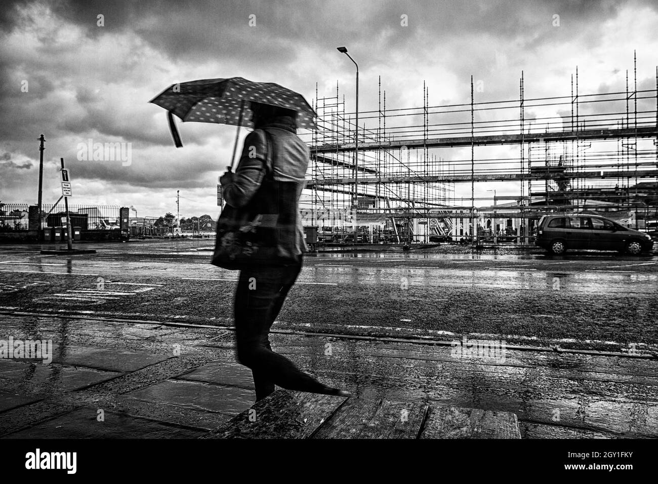 Walking in the rain, Govanhill, Glasgow, Scotland Stock Photo