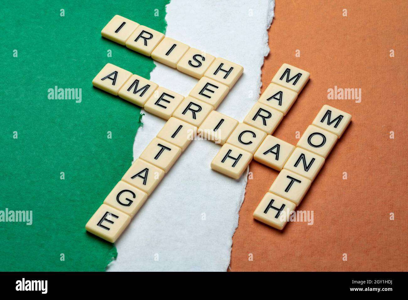 March - National Irish American Heritage Month, crossword on a paper abstract in colors of national flag of Ireland (green, white and orange), reminde Stock Photo