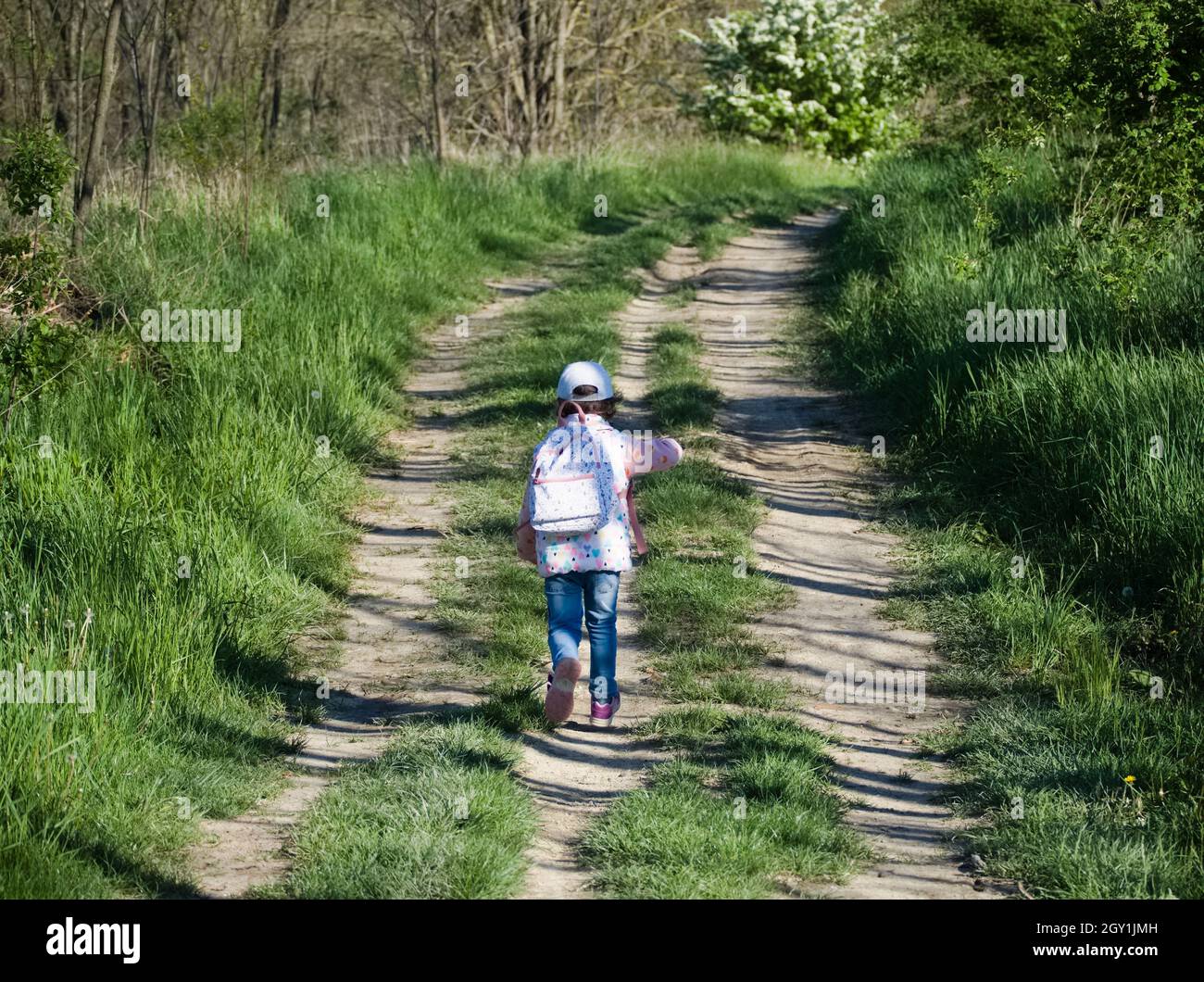 Little Girl Running away on a Dirt Road Stock Photo Alamy