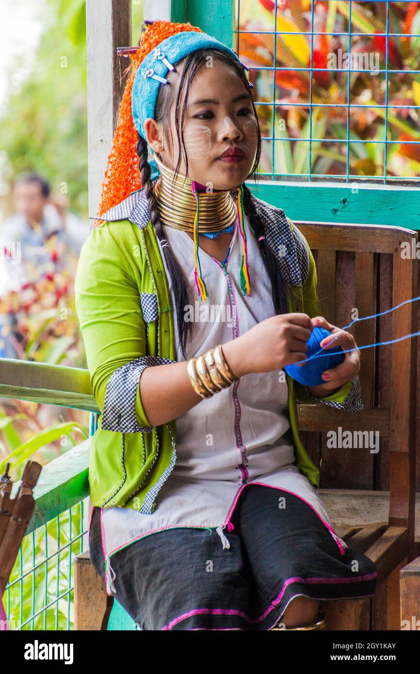 INLE, MYANMAR - NOVEMBER 28, 2016: Kayan long neck woman working in a fabric workshop at Inle lake, Myanmar Stock Photo