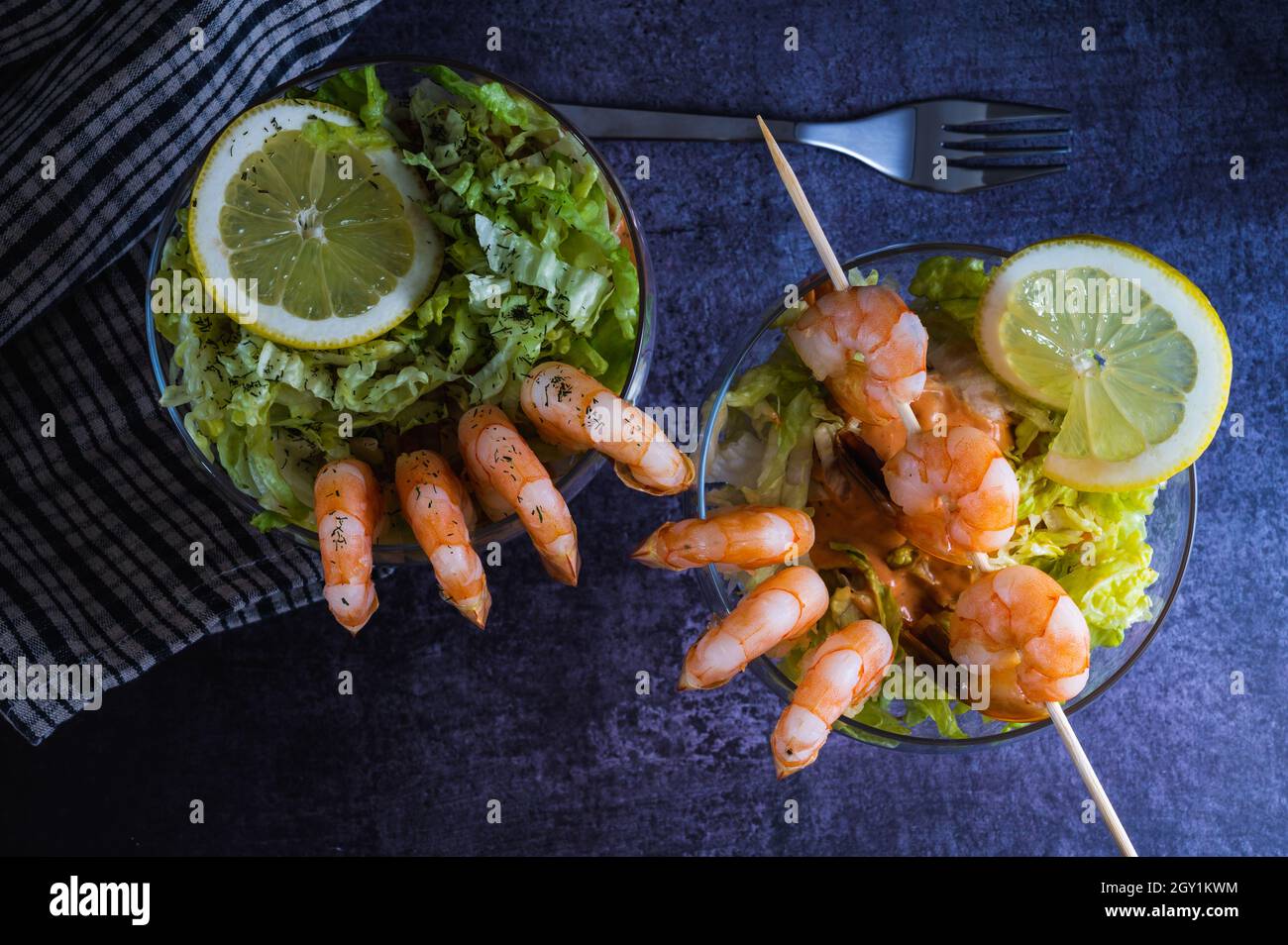 Seafood Prawn cocktail starter served in a tropical tourist restaurant in a glass with decoration of prawn with maionese sauce, lemon, lettuce and alc Stock Photo