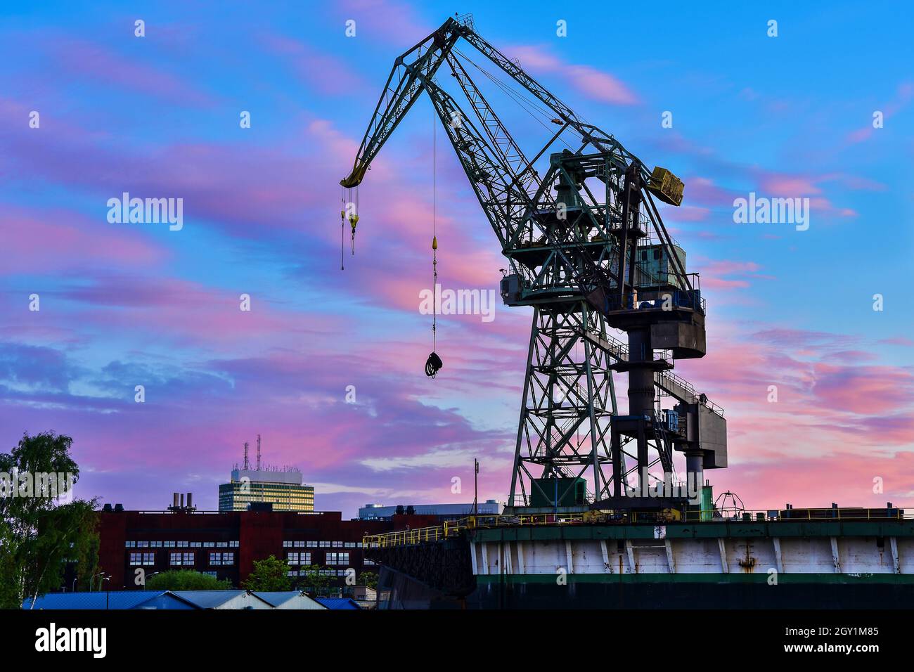 Beautiful sunset and cranes in a shipyard in Gdansk, Poland Stock Photo