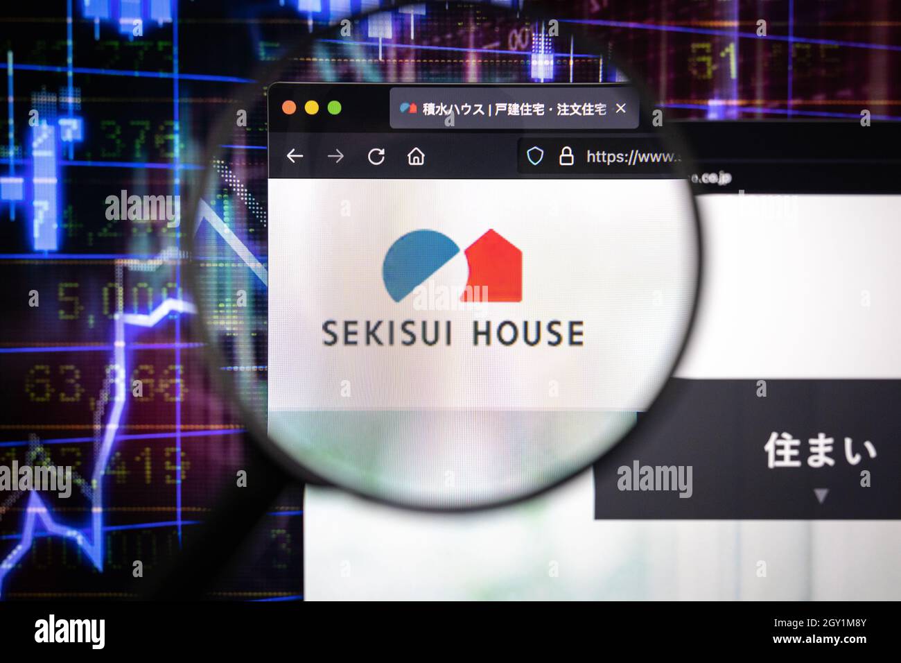 Sekisui House company logo on a website with blurry stock market developments in the background, seen on a computer screen through a magnifying glass Stock Photo