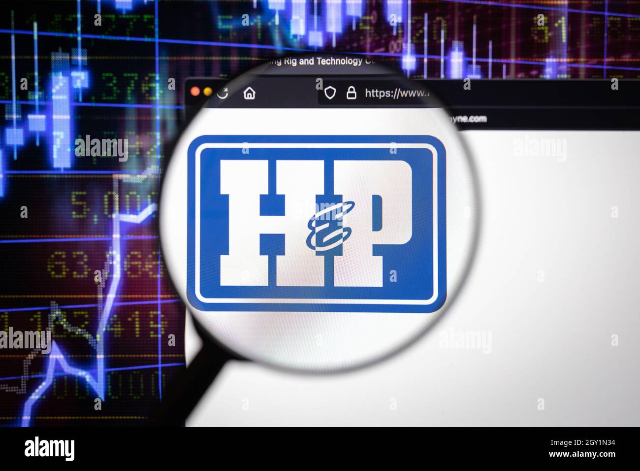 Helmerich and Payne company logo on a website with blurry stock market developments in the background, seen on a computer screen Stock Photo