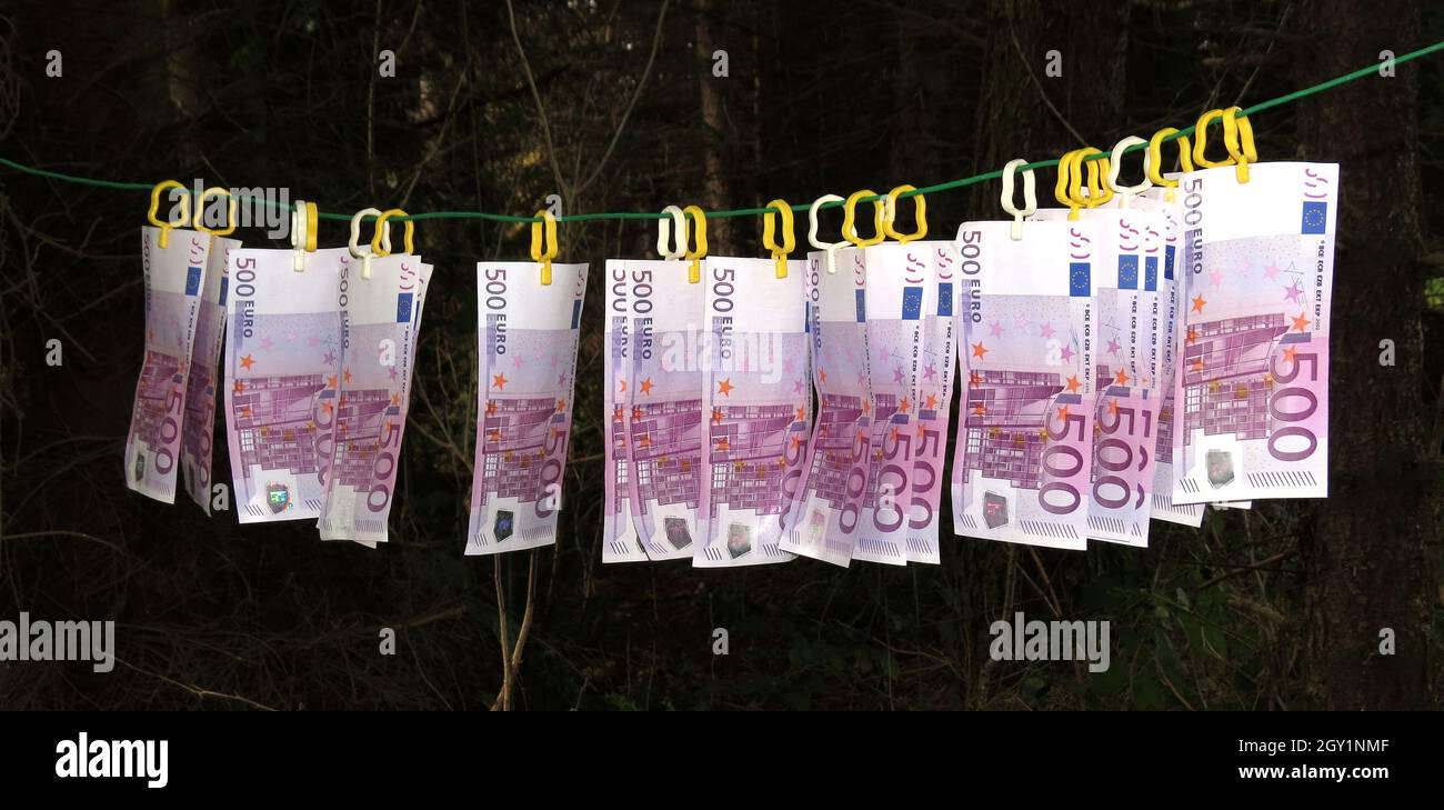 money laundering - banknotes hanging on clothes line Stock Photo