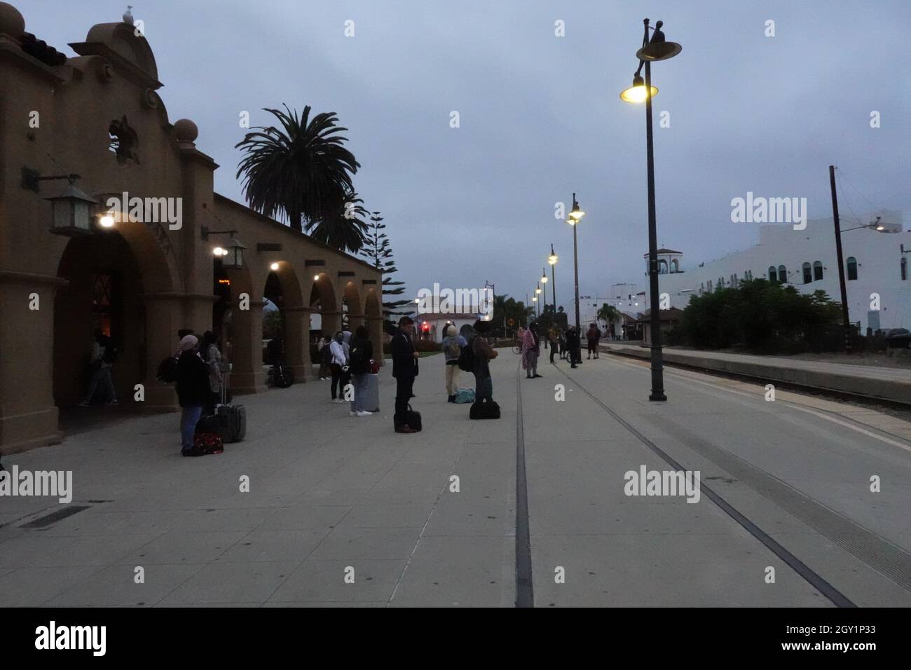 Early morning travellers waiting for the train to Los Angeles at Santa Barbara rail station, California, USA Stock Photo