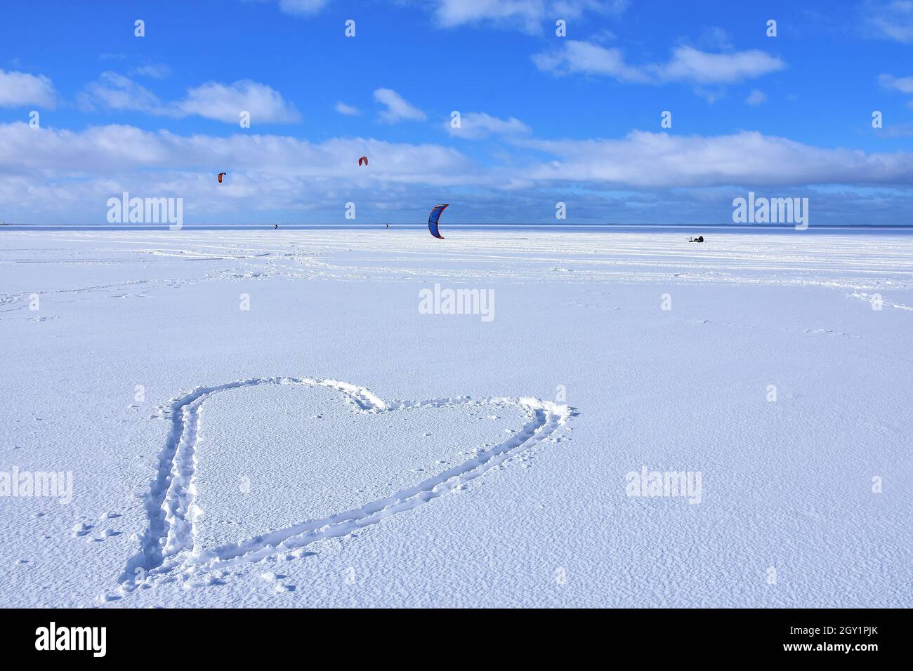 Heart in the snow. Kitesurfing in winter on ice. The Vistula Lagoon in Poland, a beautiful landscape. Stock Photo