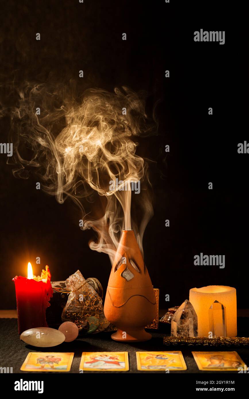 Still life with tarot cards, candles, incense and other objects on a ...
