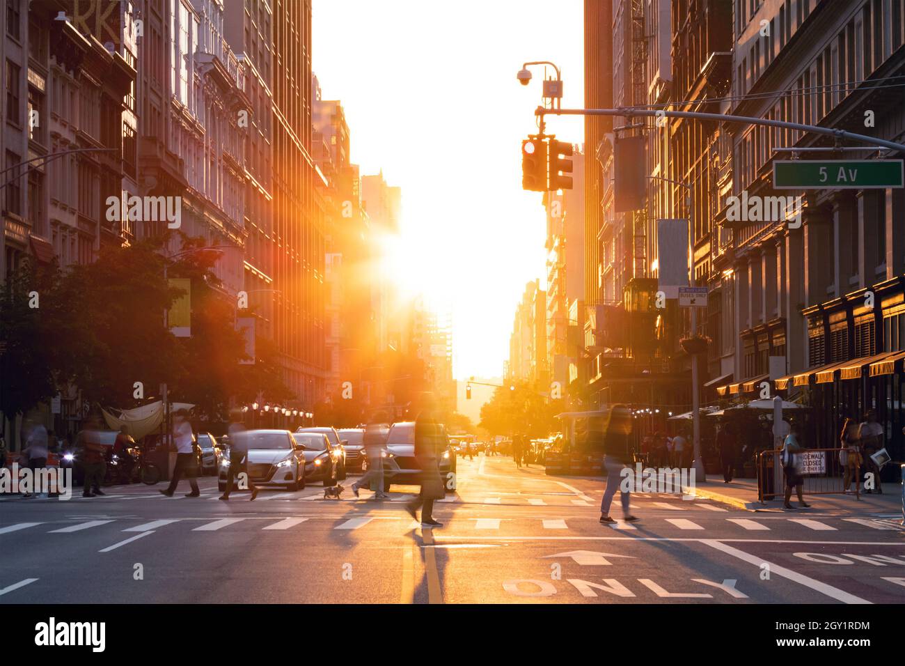 Busy street scene in New York City with crowds of people walking across ...