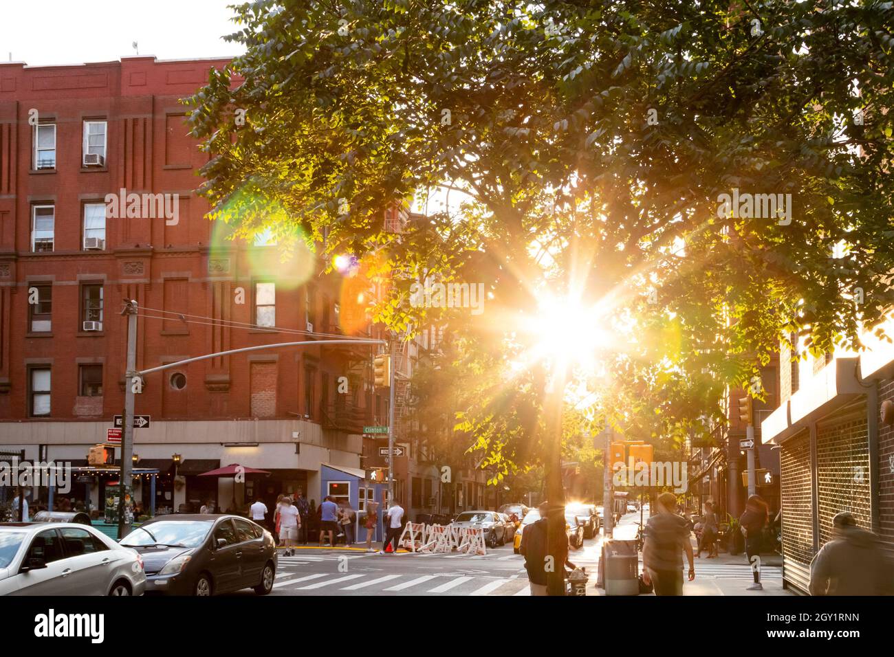 Sunlight shining on the busy intersection on Clinton Street in the Lower East Side neighborhood