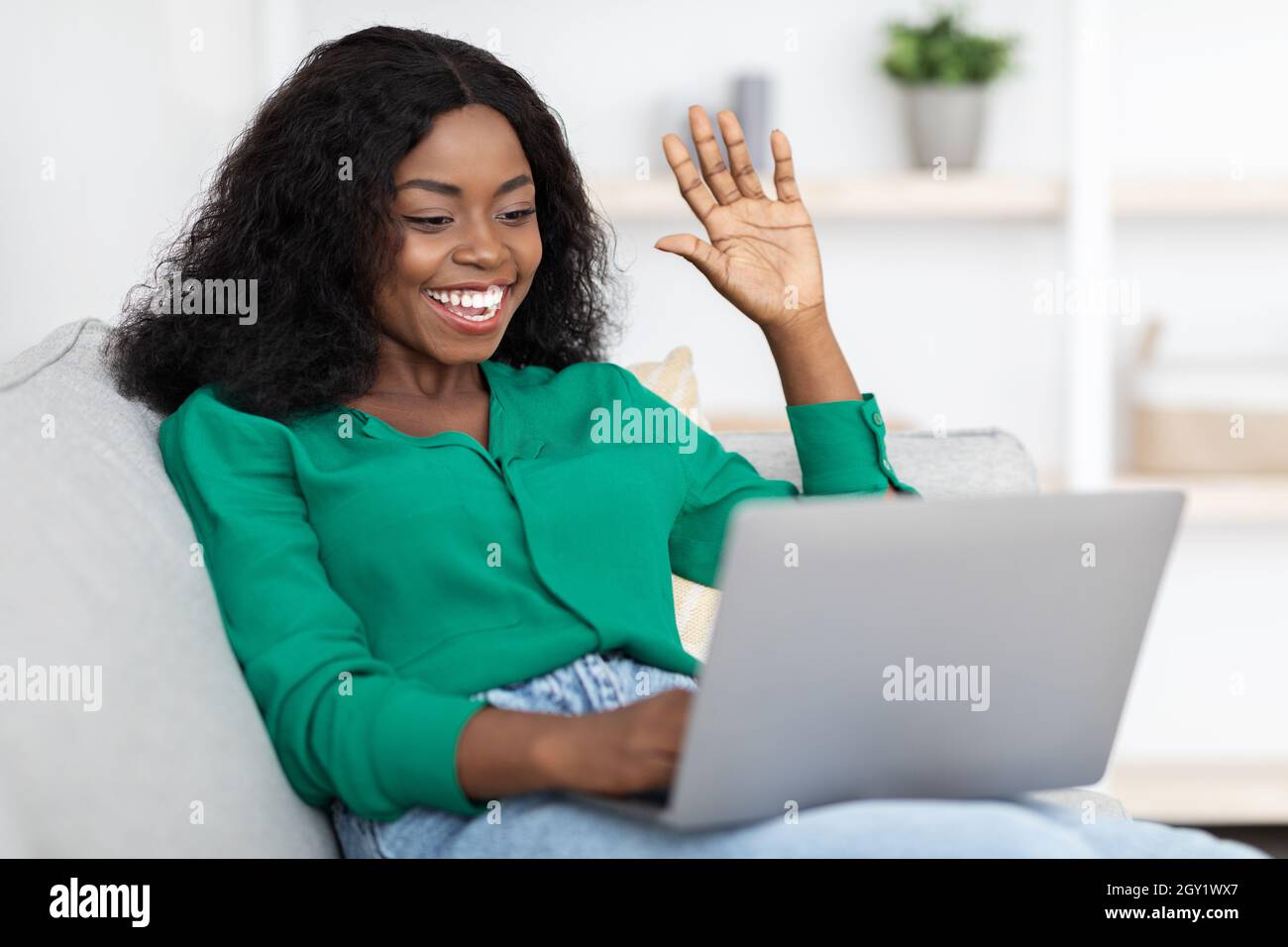 Cheerful black woman laptop hi-res stock photography and images - Alamy