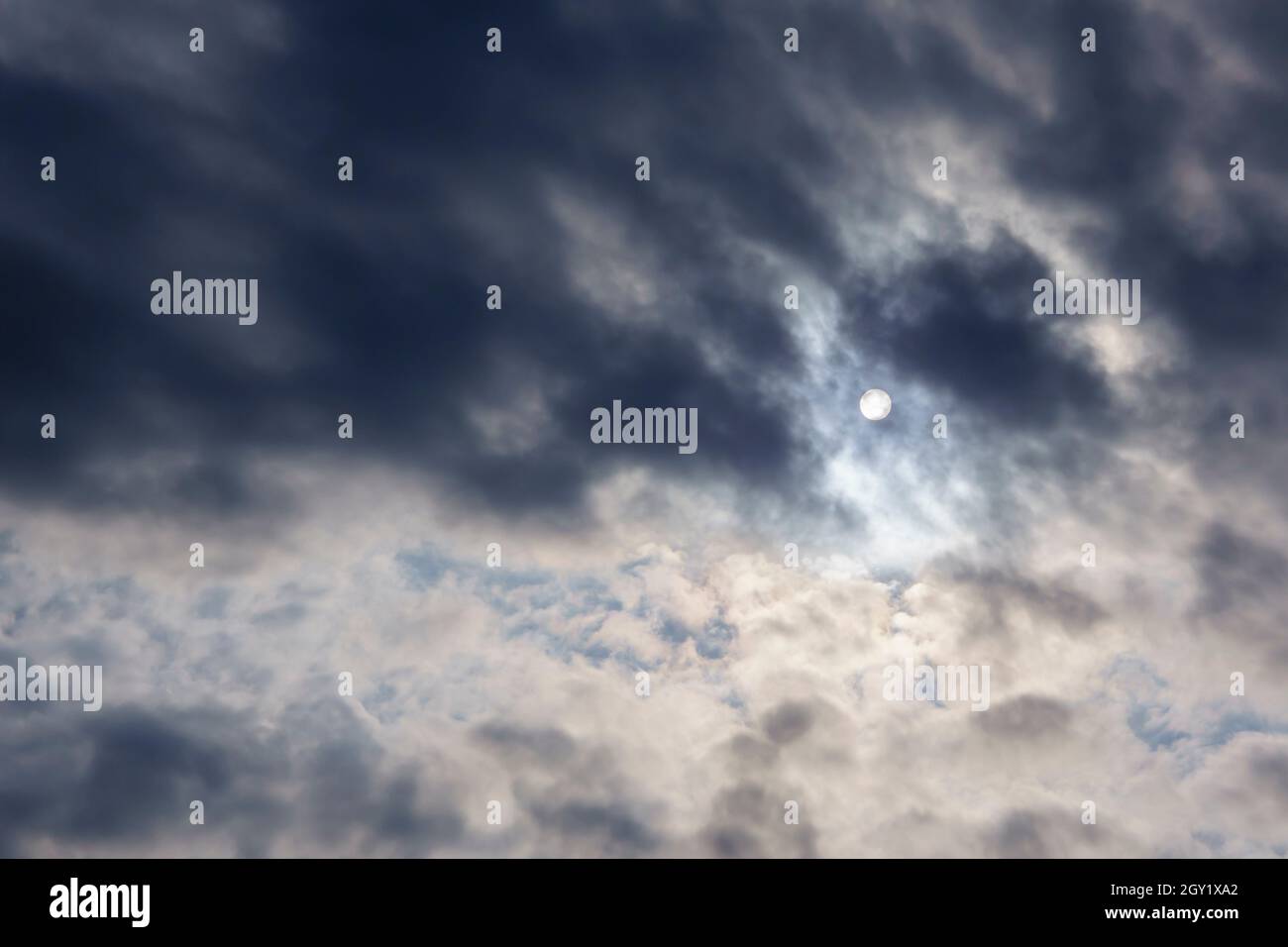Cloudy weather, the sun through the clouds, gloomy depressive background Stock Photo