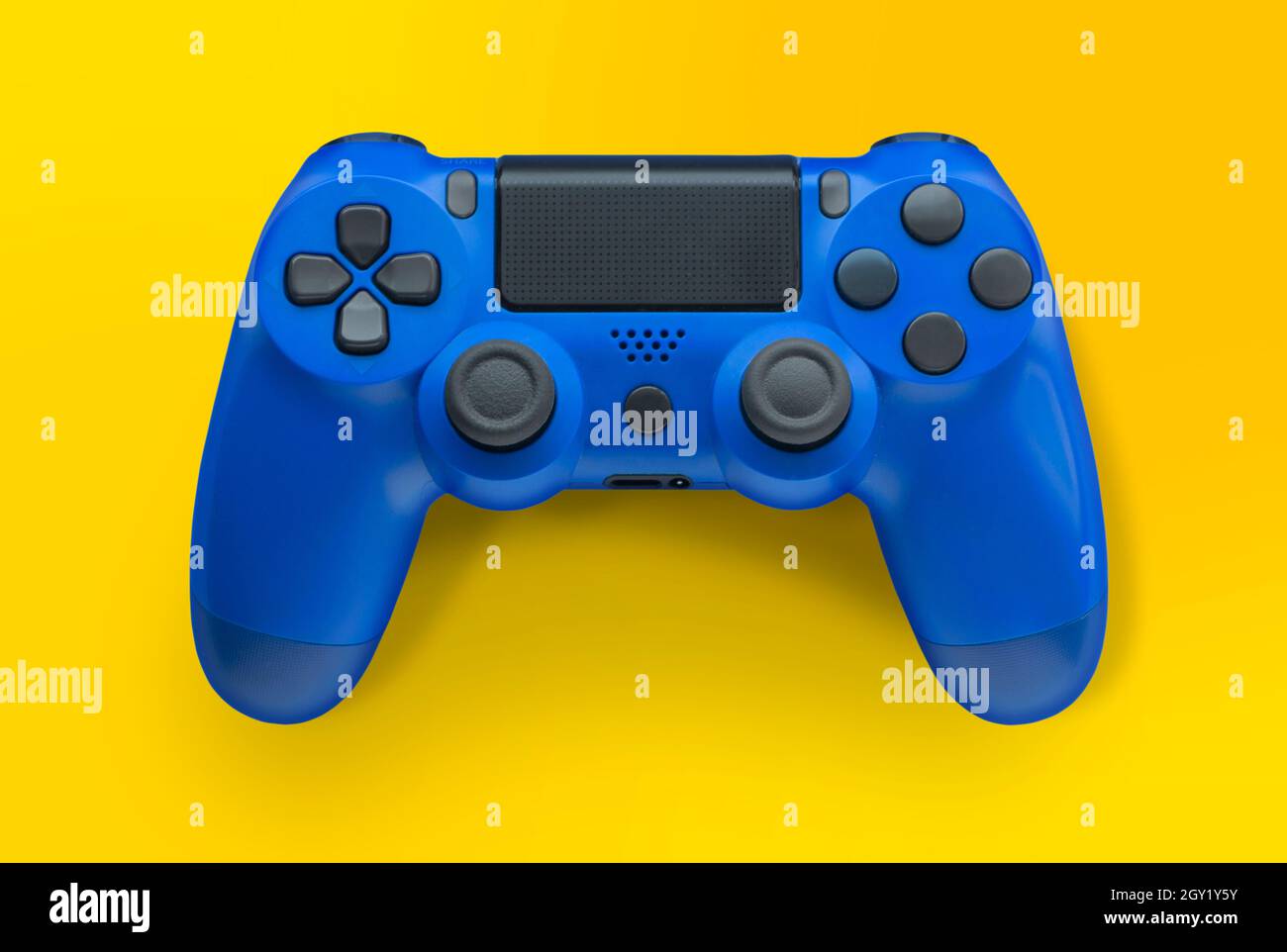 Blue video game controller isolated on a yellow background Stock Photo