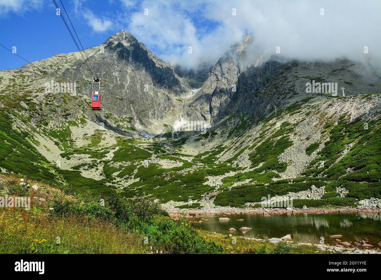 Red cable car from the Tatra Mountains to the Lomnicky Peak. Beautiful mountain landscape in Slovakia. Stock Photo