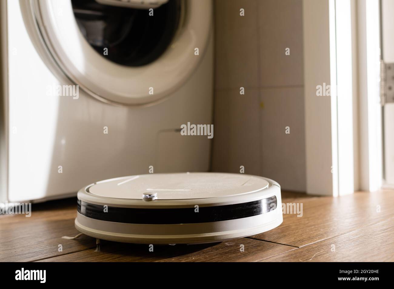 Robotic drone vacuum cleaner on laminate wood floor smart cleaning  technology Stock Photo - Alamy