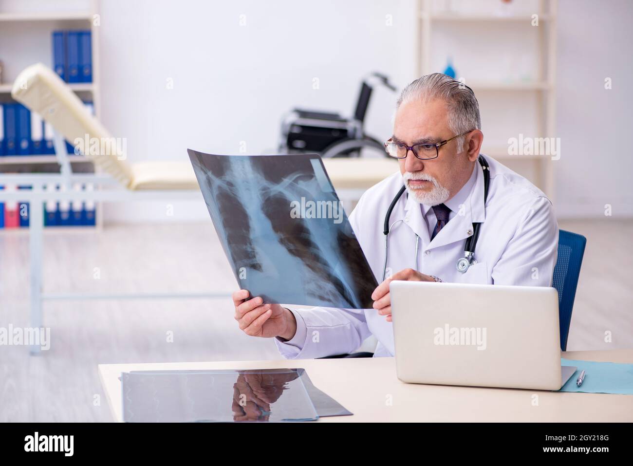 Old doctor radiologist working at the hospital Stock Photo - Alamy