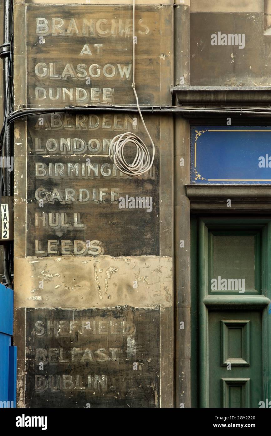 Old sign on shopfront in Victoria Street, Edinburgh listing branch locations in the UK and Ireland. Stock Photo