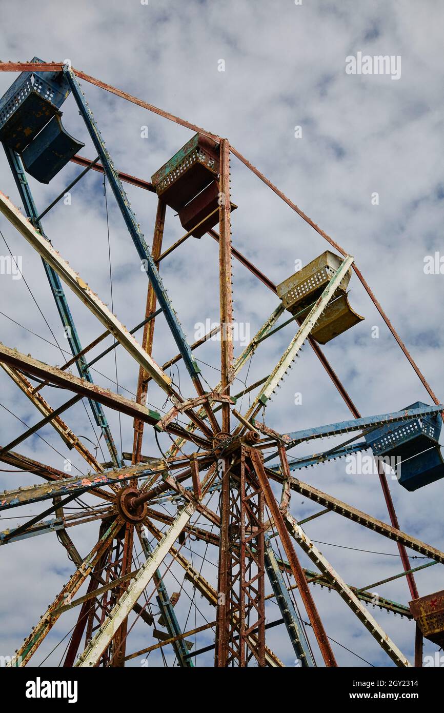 Worm's eye view of a ferris wheel at an abandoned theme park Stock Photo
