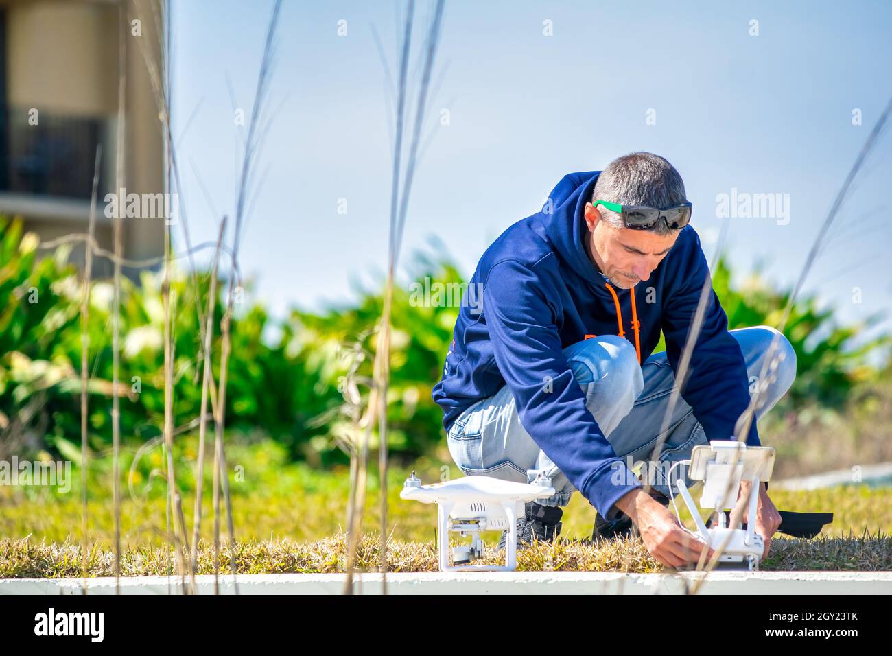 Man setting up his drone for flying over the beach Stock Photo