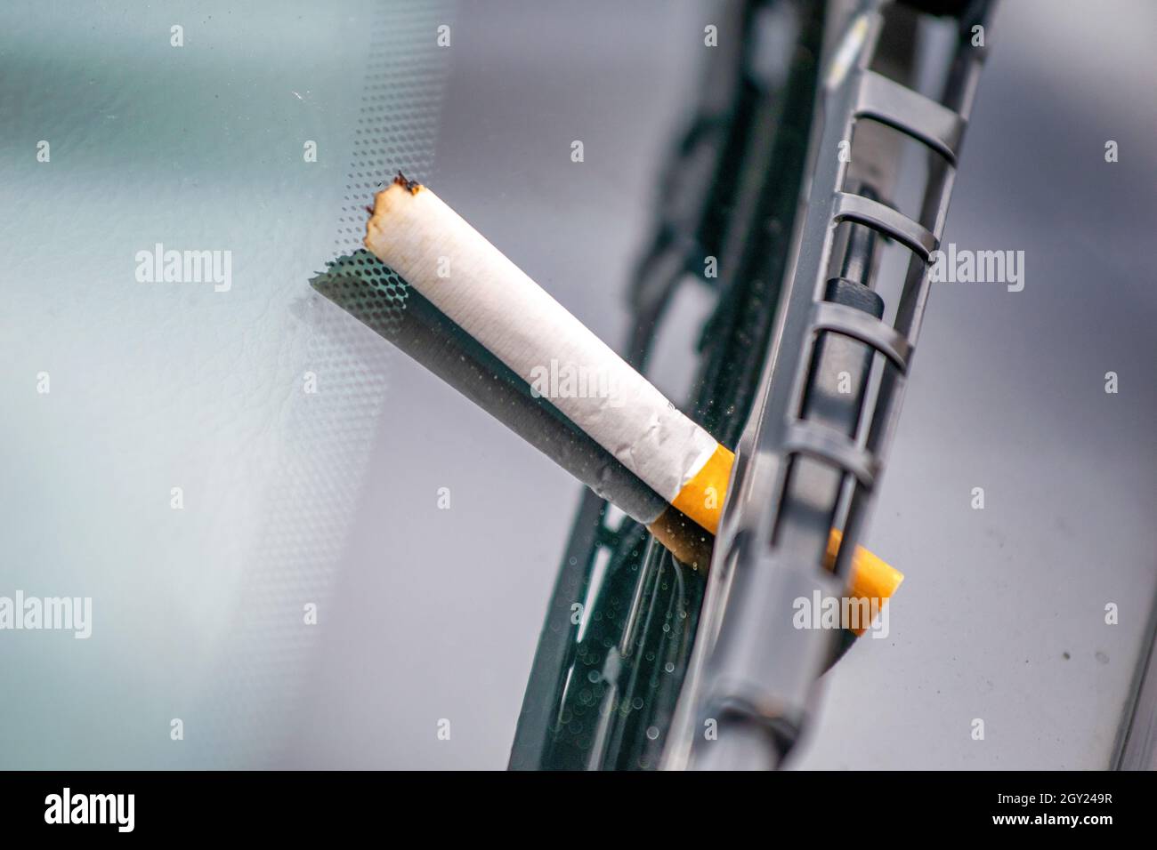 use-cigarette-under-a-car-windshield-wiper-smoker-concept-stock-photo