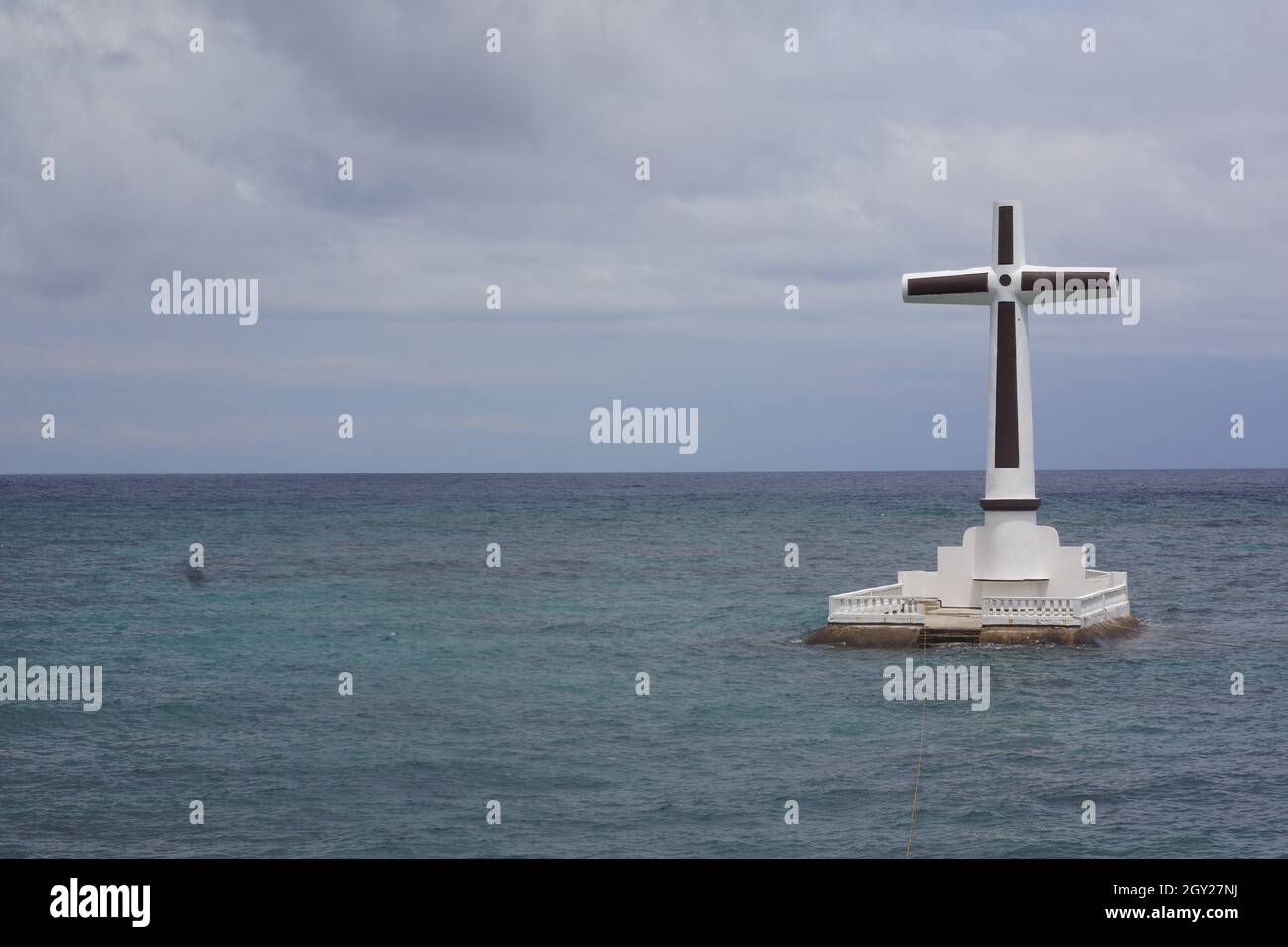 CATAR, PHILIPPINES - Aug 16, 2015: A big cross on the Sunken Cemetery, town of Catarman, Camiguin island province, Philippines Stock Photo