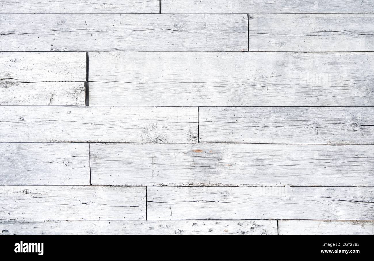 Crackled paint finish on white wood planks. Aged reclaimed barn wood